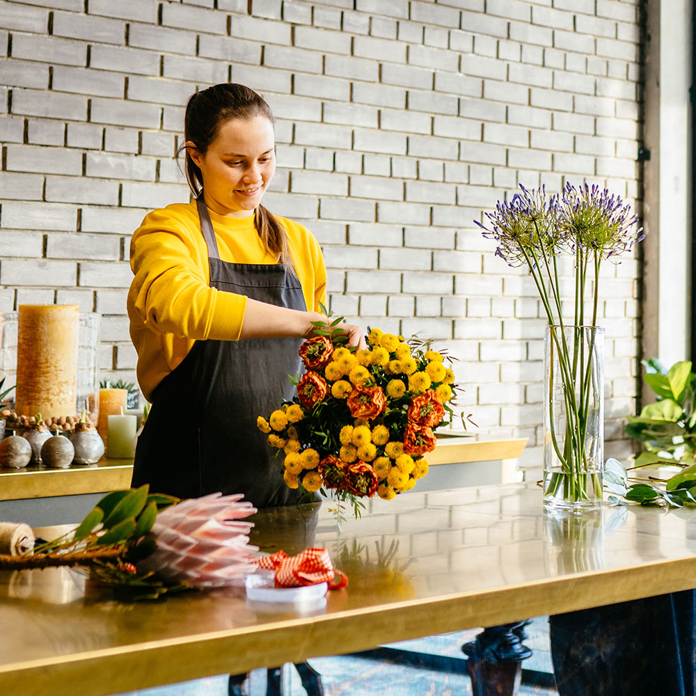 woman arranging flowers