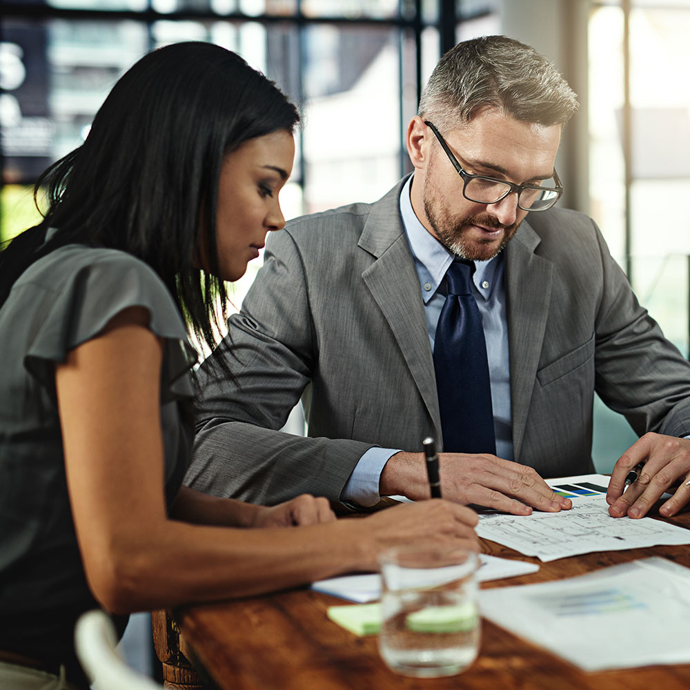 Woman and man reviewing papers in an office environment