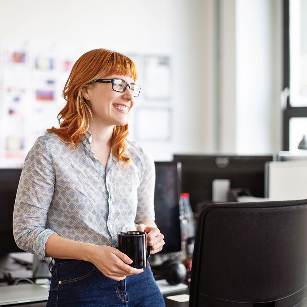 woman business person standing in office with coffee