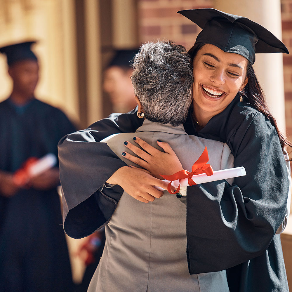 Woman hugging older woman at a graduation ceremony