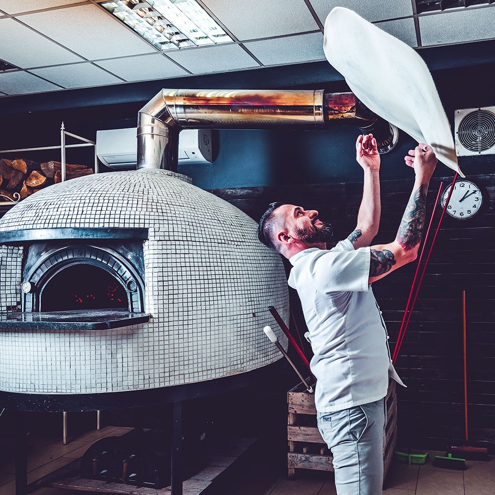 man making pizza