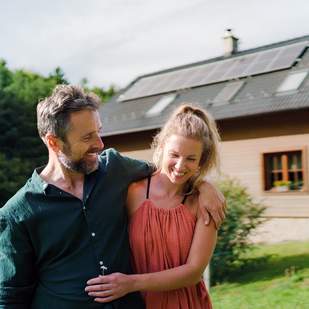 Couple by house with Solar panels