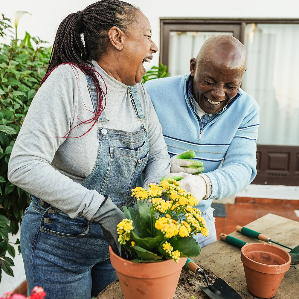 Couple planting flowers