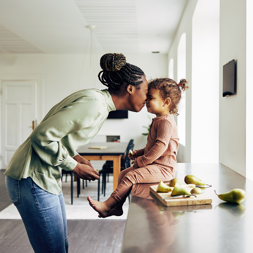 Mother and daughter sharing fruit