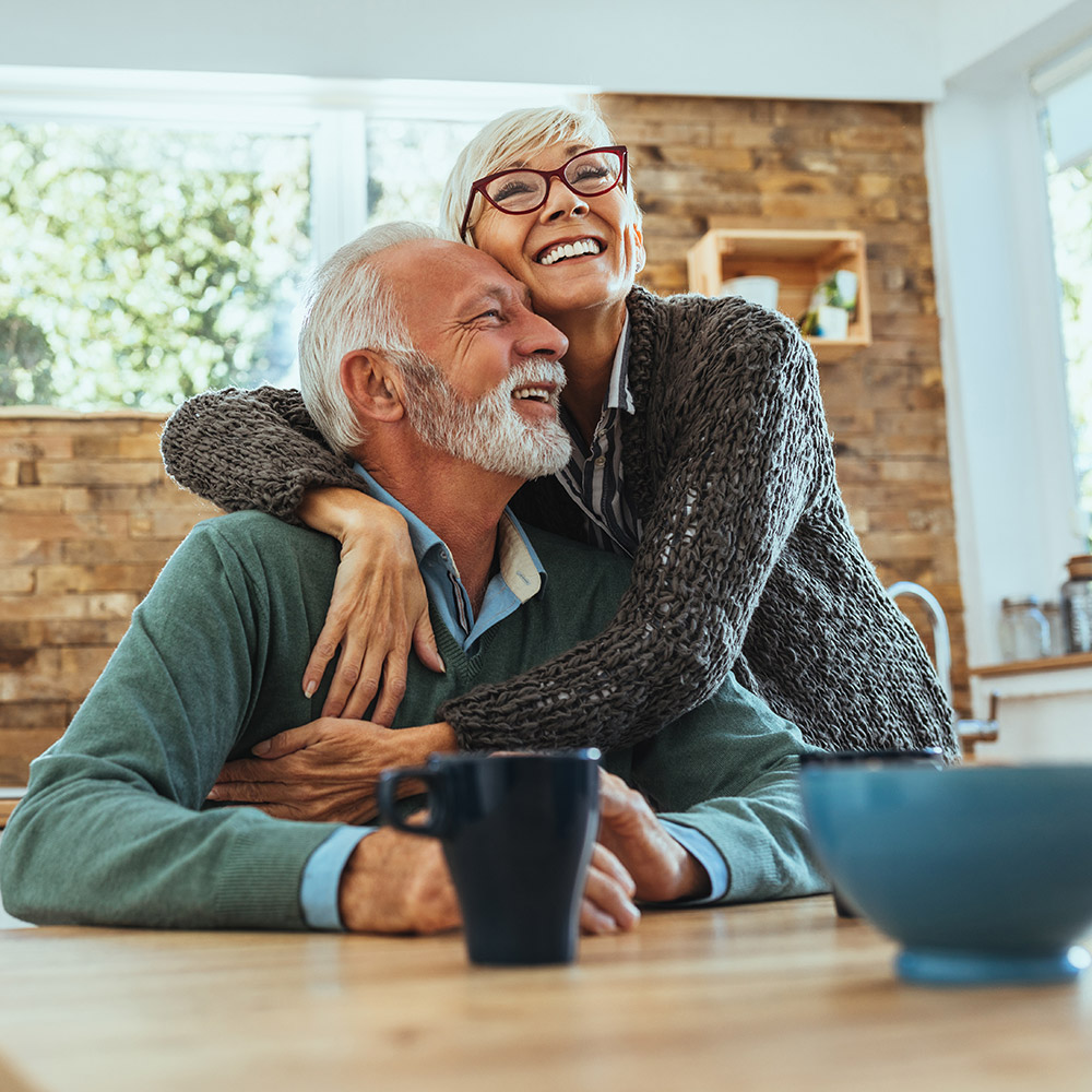 Couple embrace in kitchen