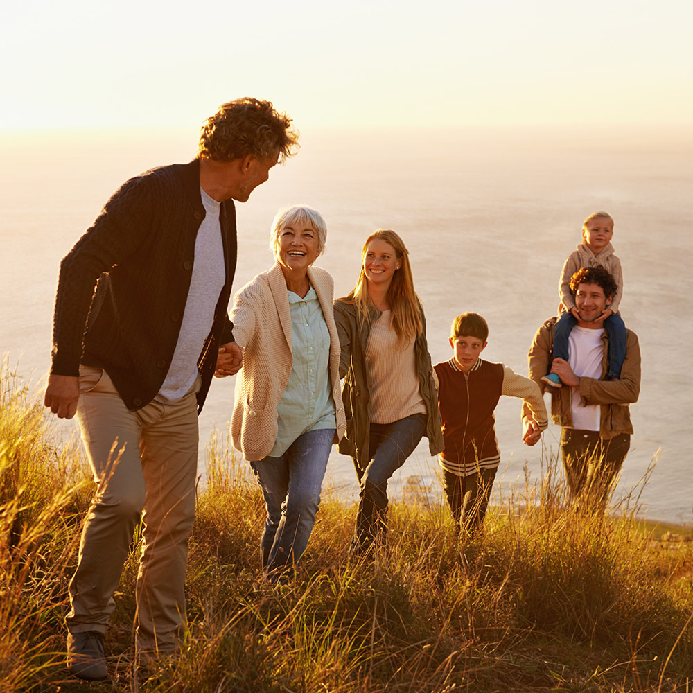 extended family on beach at sunset