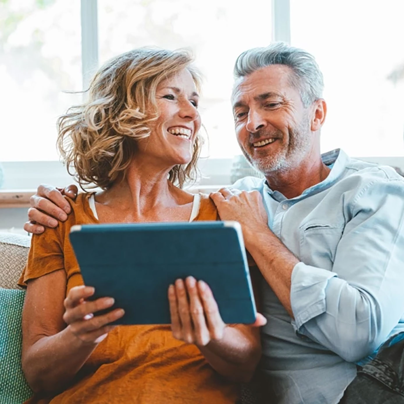 Couple on couch with tablet