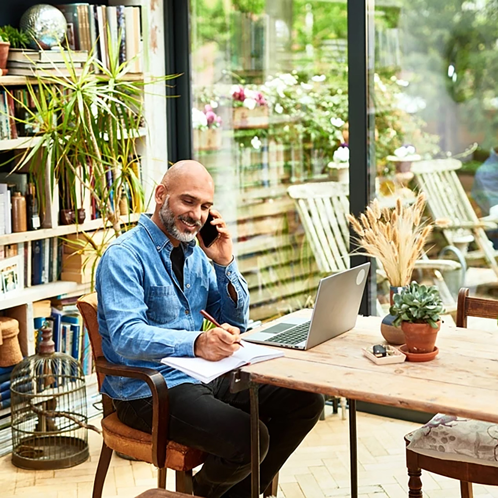 Man working at table with laptop