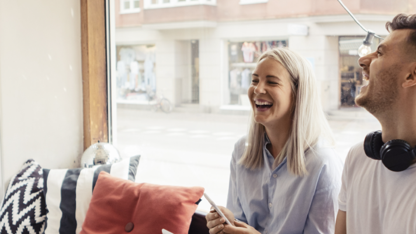 Couple laughing on a couch