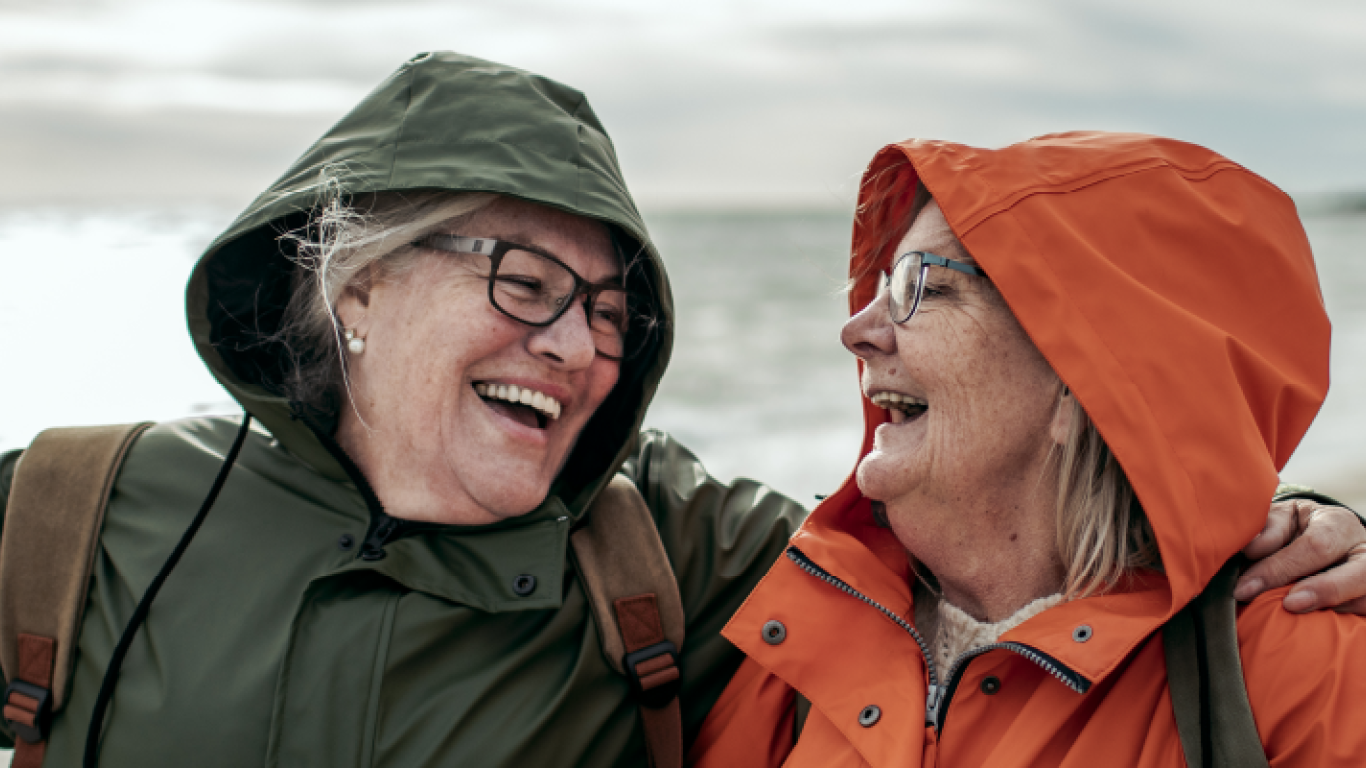 older couple laughing on the beach