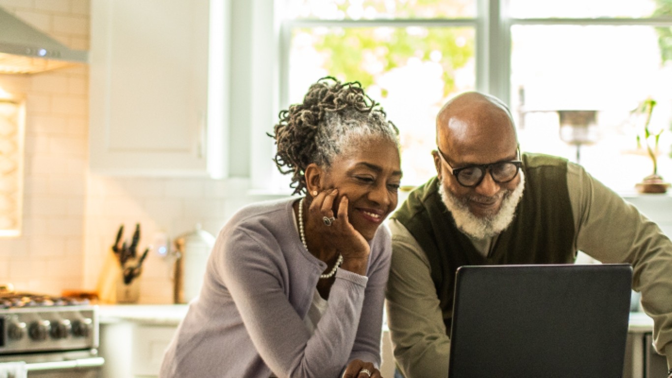 older couple looking at laptop and smiling