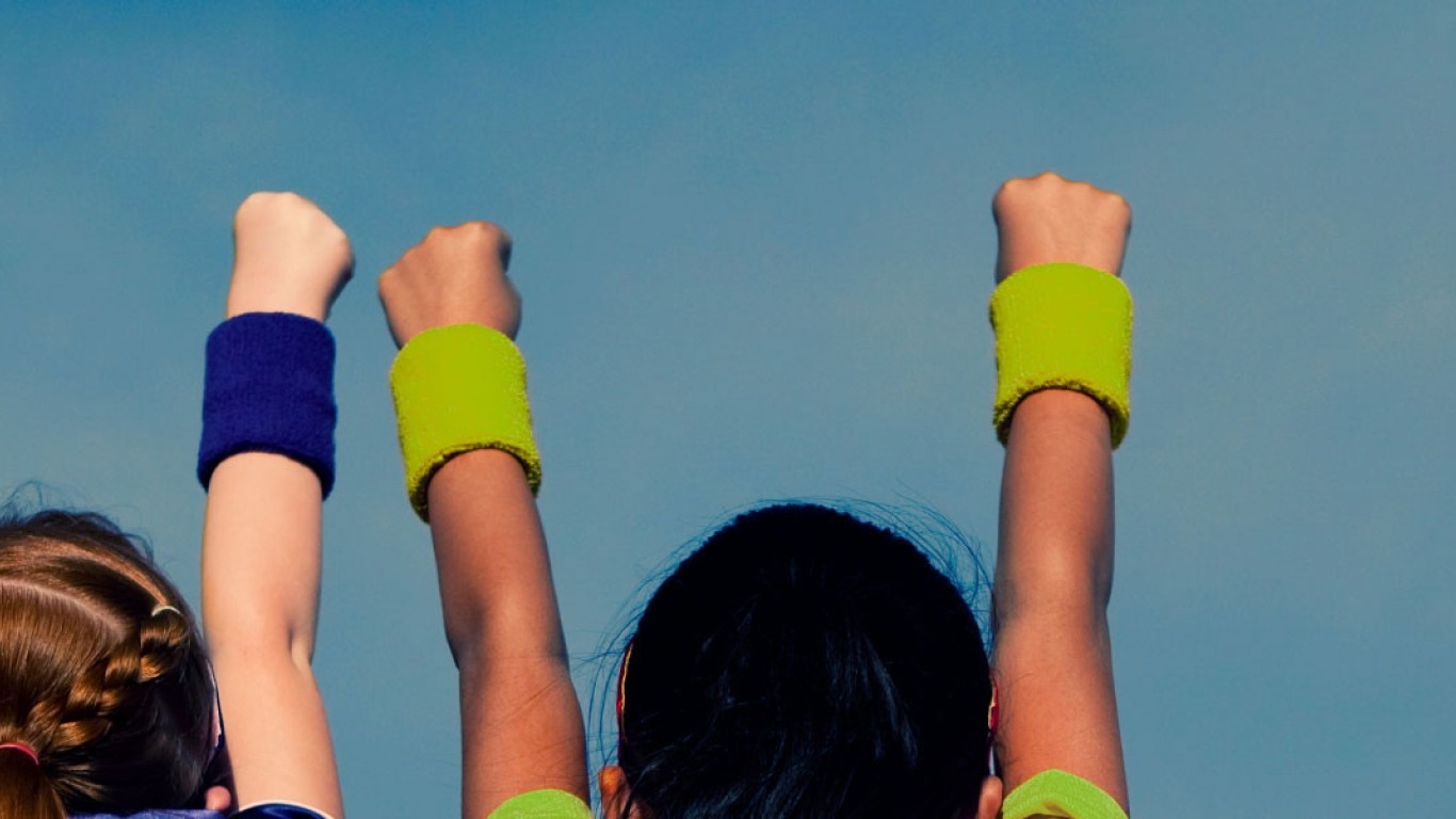 children with hands raised in a triumphant manner