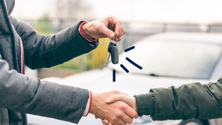 Some hands the keys to a new car owner