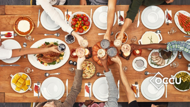 Thanksgiving image with a group meal at a long shared table