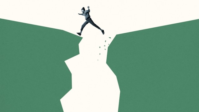 Girl stepping across large space between two large green cliffs.