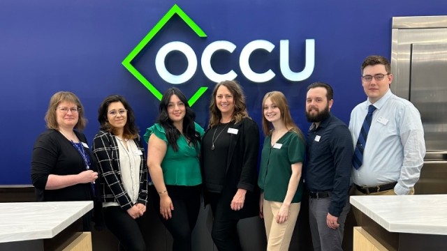 OCCU Roseburg branch team staff posing in a group with smiles.