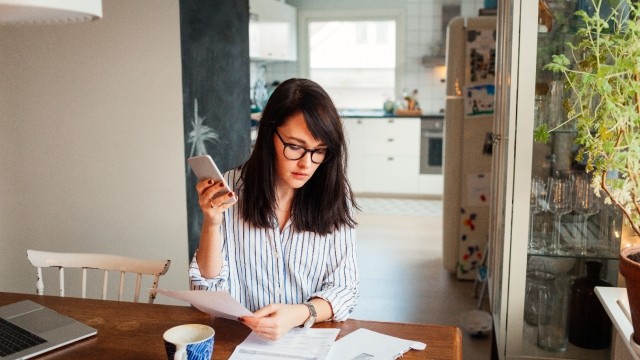 Woman looking at bills