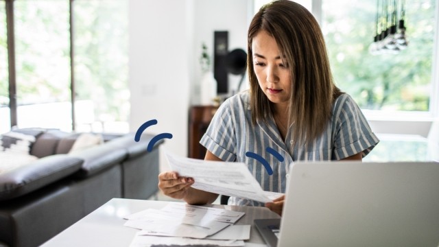 Woman looking at bills