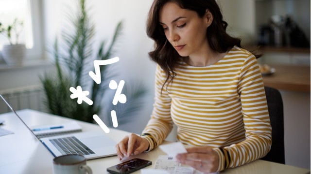 Woman works at a computer with math doodles in the air around her.