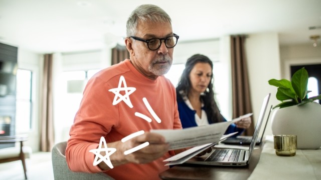 Man looks at bills with doodles in the air.