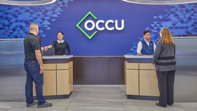 Bank tellers assisting members in an OCCU credit union branch.