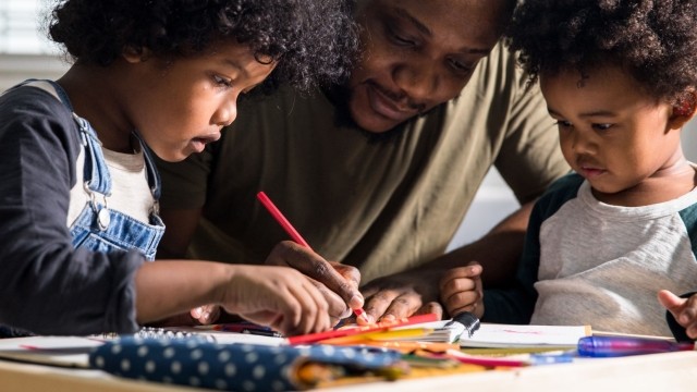 Dad coloring with sons