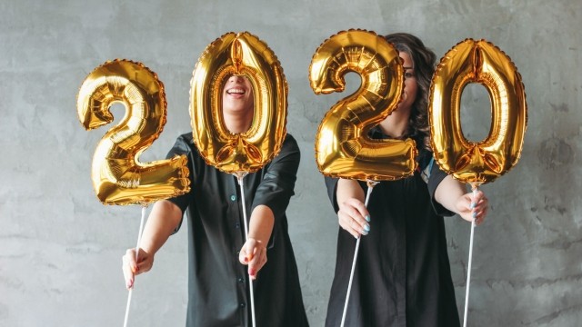 People holding 2020 balloons