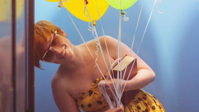 Young woman with balloons in an elevator