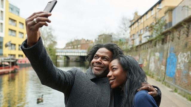 African American couple taking selfie