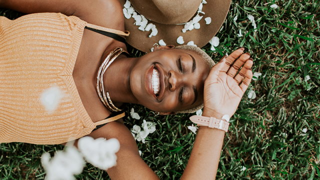 young woman laying in the grass with spring flowers