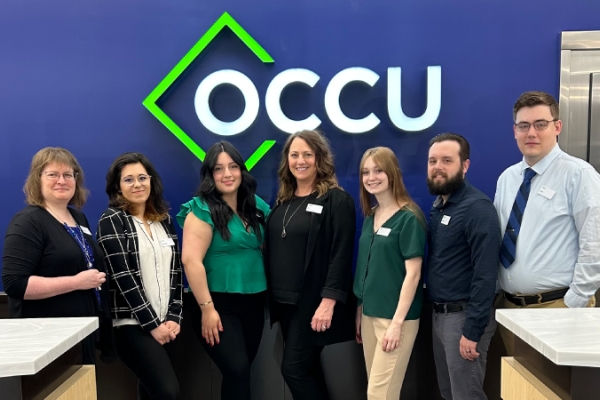 OCCU Roseburg branch team staff posing in a group with smiles.