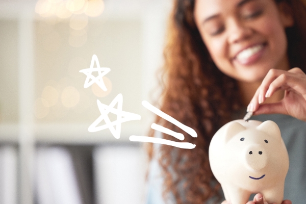 woman putting money in piggy bank