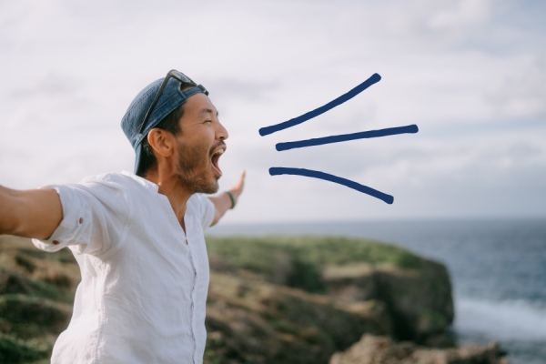 Man yells from the mountain top. 