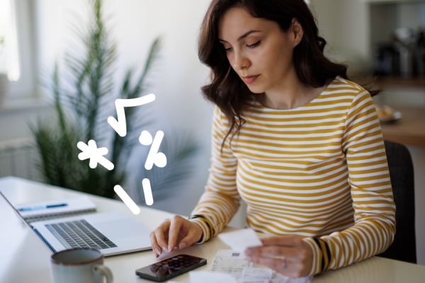 Woman works at a computer with math doodles in the air around her. 