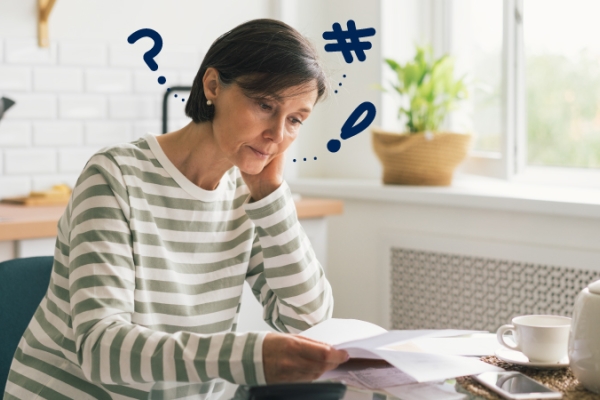Woman looking at paperwork at her kitchen table
