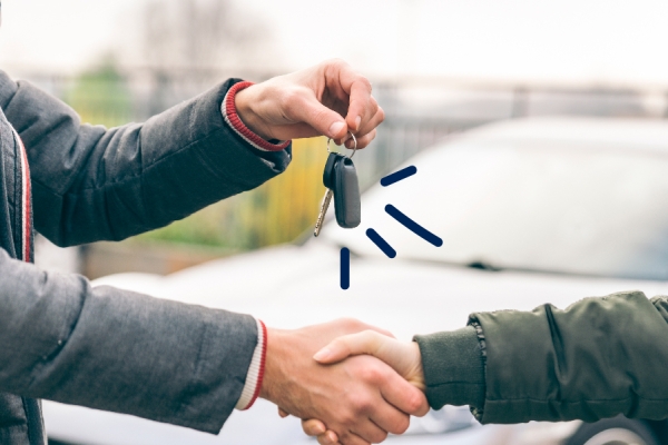 Some hands the keys to a new car owner