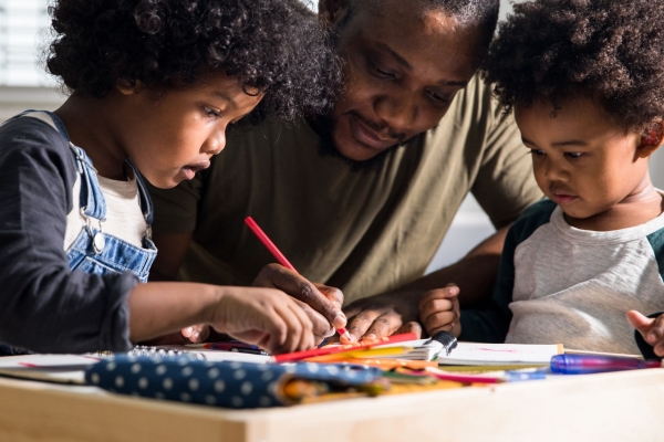 Dad coloring with sons