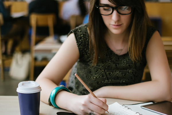 Female college student studying in library