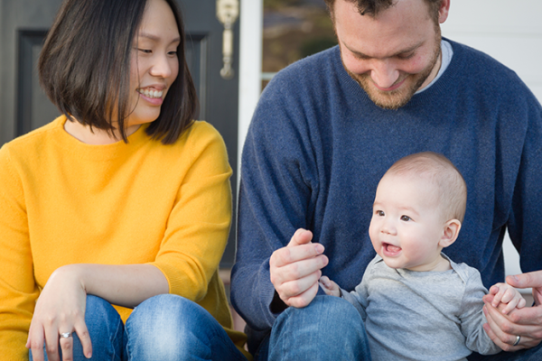 Couple with young child on front porch