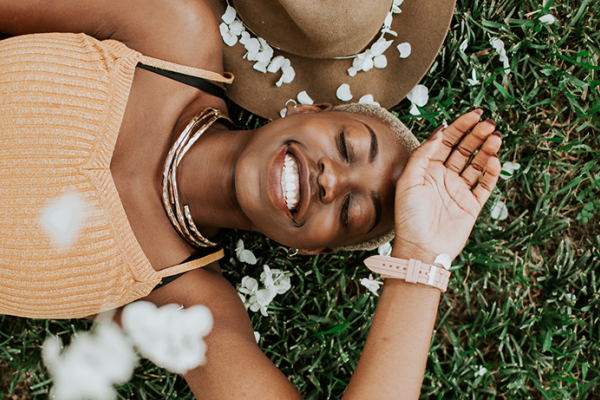 young woman laying in the grass with spring flowers