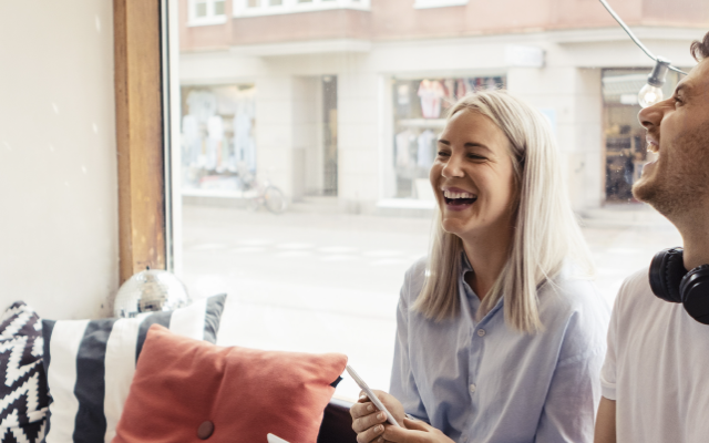 Couple laughing on a couch