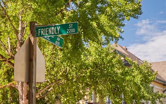 Panoramic view of street sign for Friendly Street
