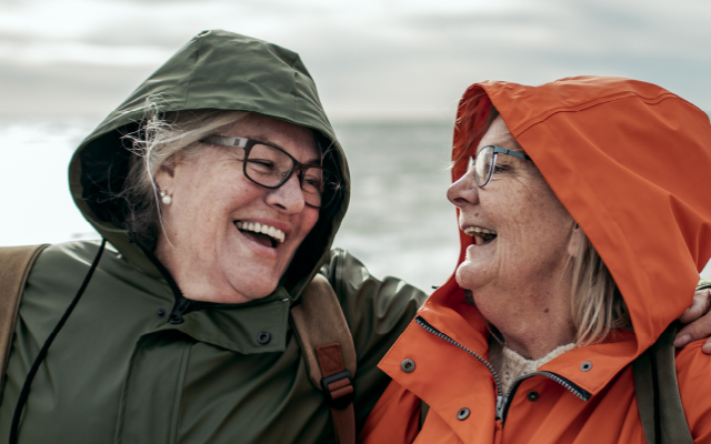 older couple laughing on the beach