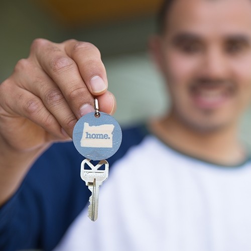 man giving key to home