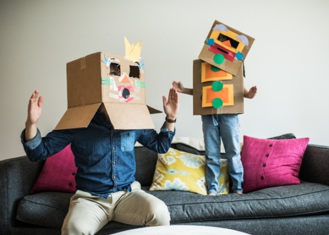 family playing with boxes on their heads