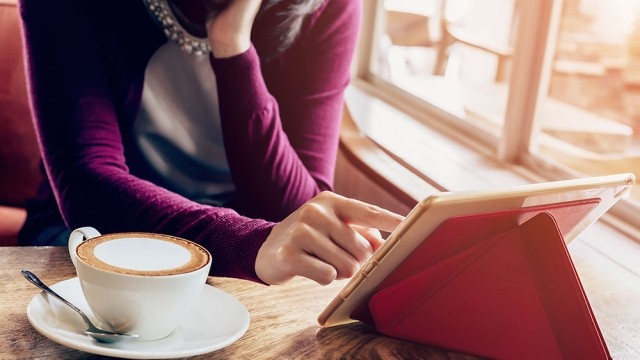 woman in coffee shop with tablet