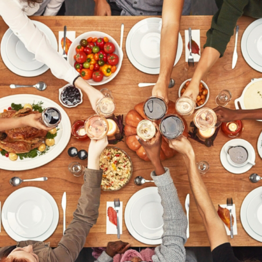 Thanksgiving image with a group meal at a long shared table