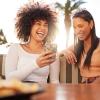 Women looking at phone over lunch